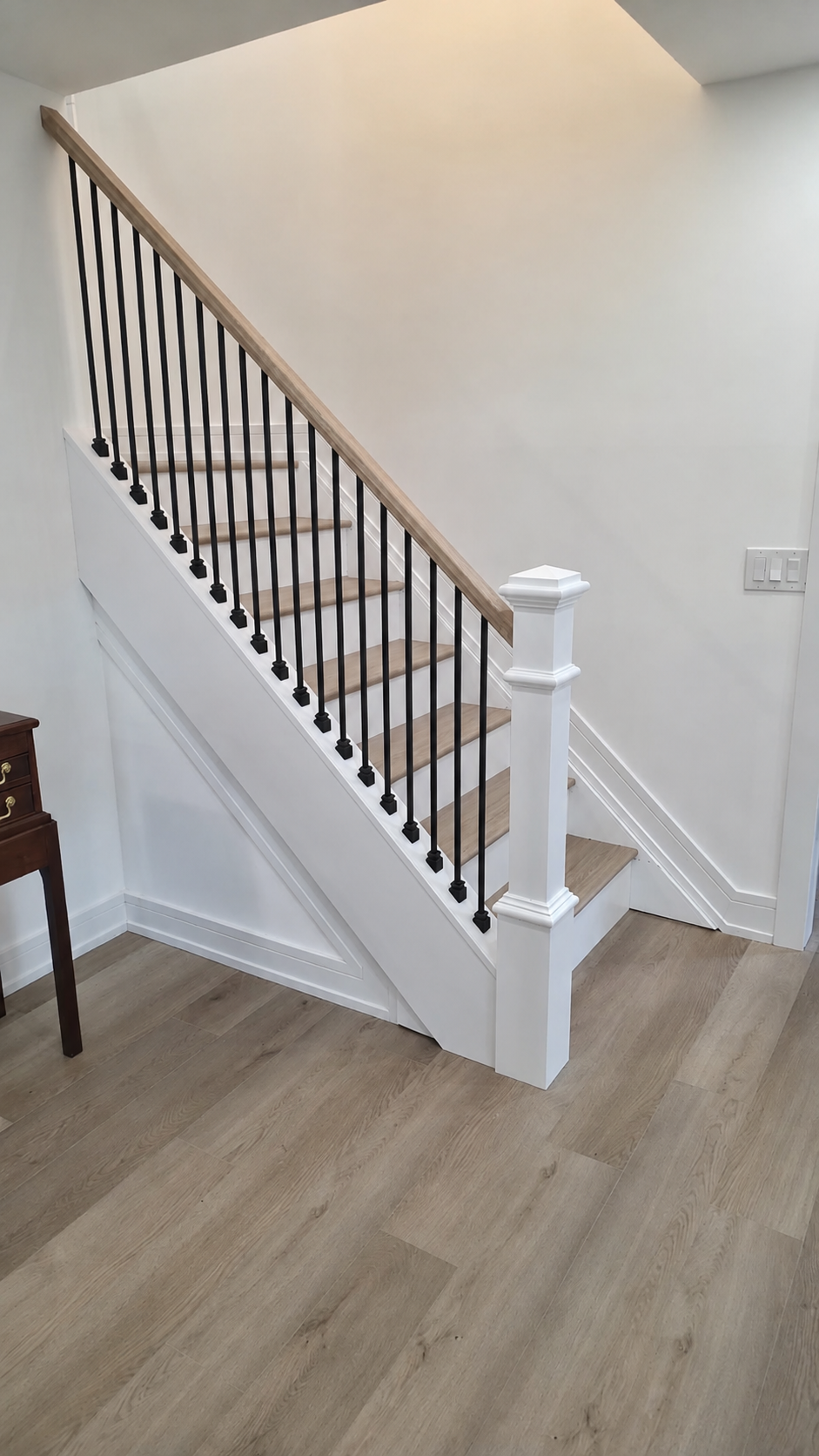 White oak stair treads with iron balusters and box newel